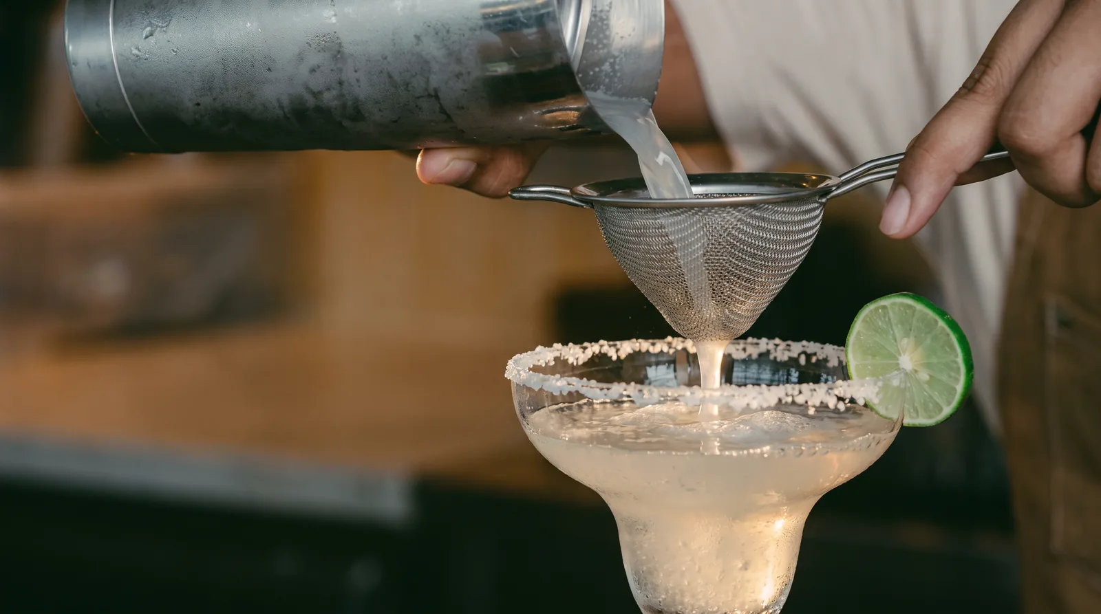Recomposed close-up of the margarita being strained.