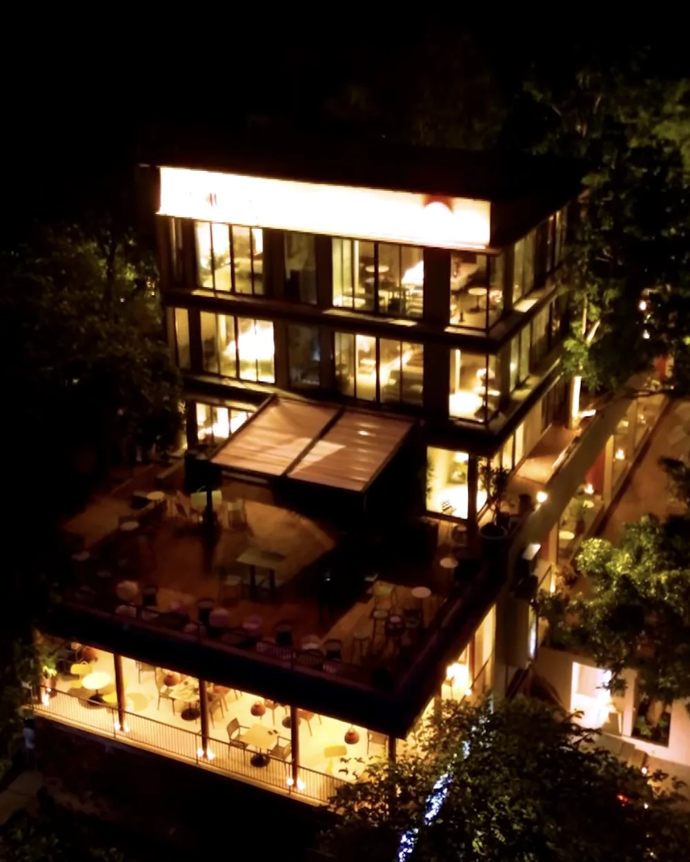 Original Instagram reel from NiiRA: the hotel lit up at night, seen from the air.